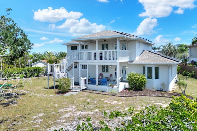4116 4th Ave NE, Bradenton, FL 34208 - back of property with a lawn, ceiling fan, roof with shingles, and stucco siding