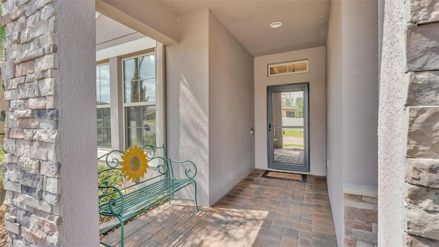 doorway to property featuring stucco siding