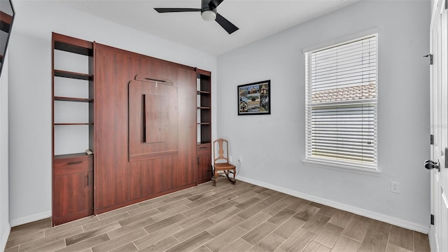 foyer with baseboards, plenty of natural light, and a ceiling fan