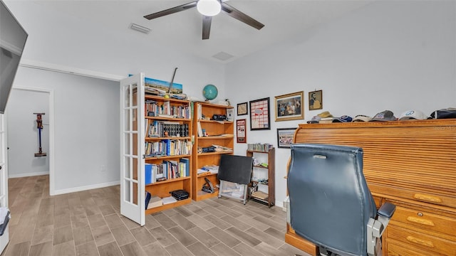 office area featuring a ceiling fan, baseboards, visible vents, and wood finished floors
