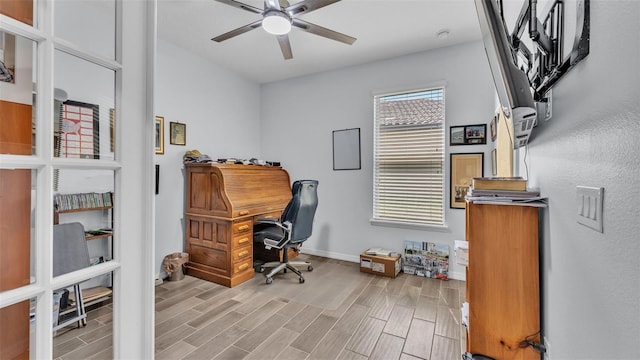 home office with light wood-style floors, baseboards, and ceiling fan