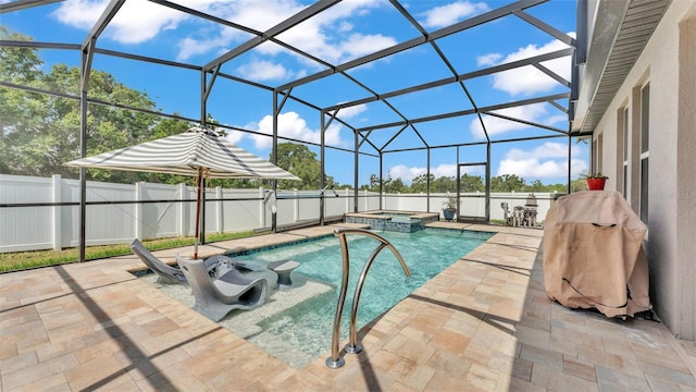 view of swimming pool featuring a pool with connected hot tub, a lanai, a fenced backyard, and a patio area