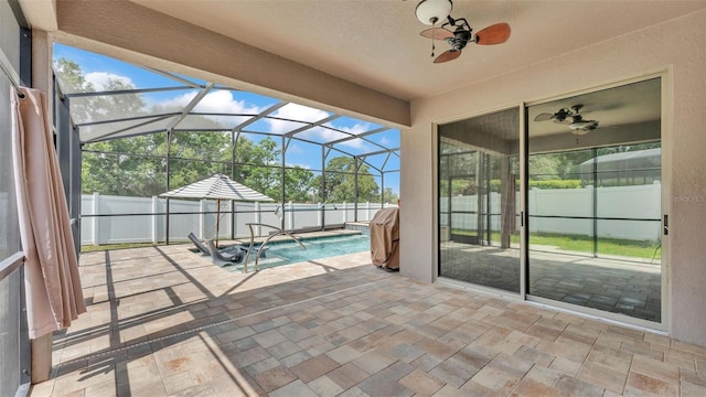 view of patio / terrace with a fenced backyard, a fenced in pool, ceiling fan, and a lanai