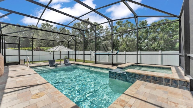 view of pool featuring a fenced backyard, a pool with connected hot tub, and a patio area