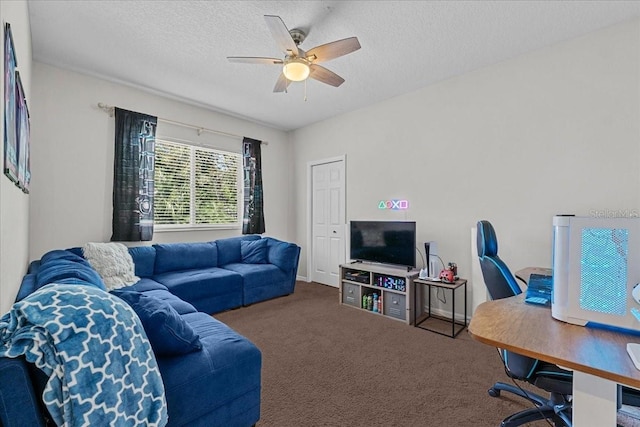 living area featuring a textured ceiling, carpet flooring, and ceiling fan