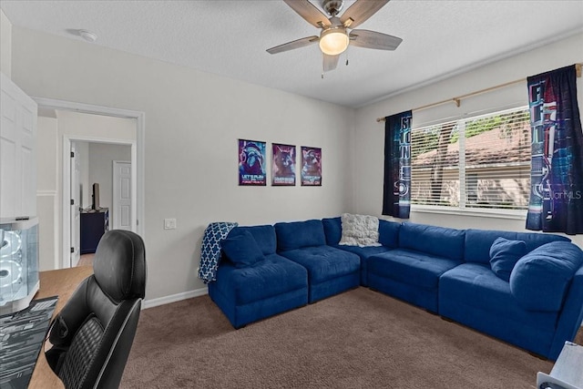 living area with ceiling fan, a textured ceiling, and carpet