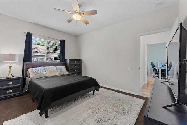 bedroom featuring wood finished floors, ceiling fan, and baseboards