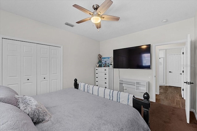 carpeted bedroom with visible vents, ceiling fan, and a closet