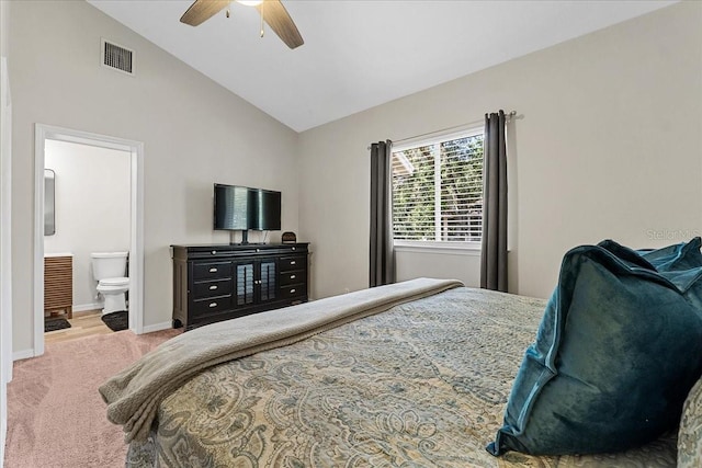 bedroom featuring carpet flooring, high vaulted ceiling, ensuite bath, visible vents, and baseboards