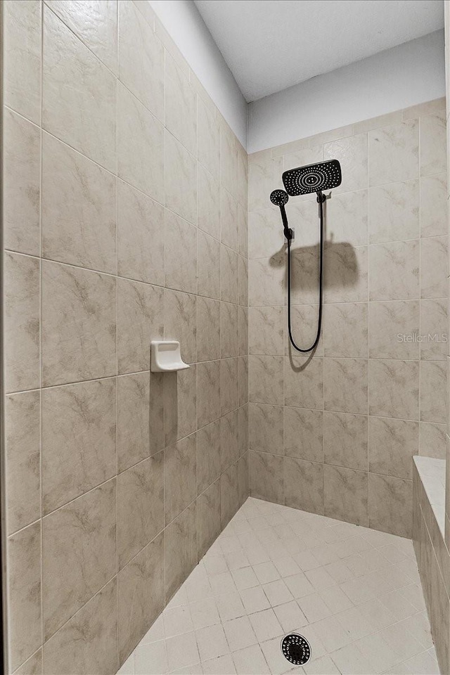full bath featuring tiled shower