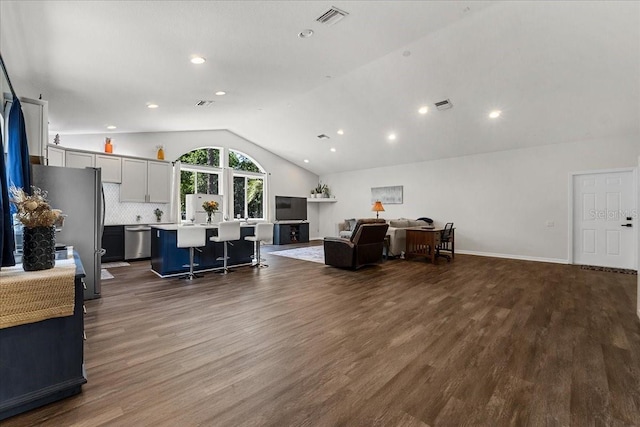 living room featuring dark wood finished floors, visible vents, recessed lighting, and vaulted ceiling
