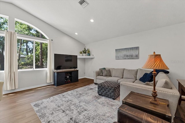 living room with wood finished floors, visible vents, recessed lighting, and vaulted ceiling