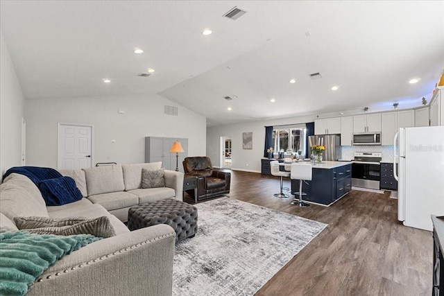 living area featuring dark wood finished floors, visible vents, lofted ceiling, and recessed lighting