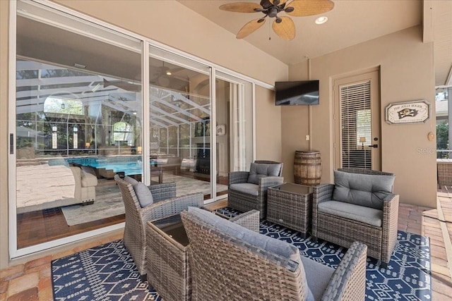 view of patio / terrace featuring an outdoor pool, a ceiling fan, an outdoor living space, and glass enclosure