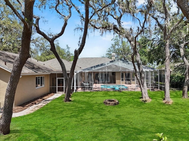 back of house featuring a lawn, an outdoor pool, stucco siding, and glass enclosure