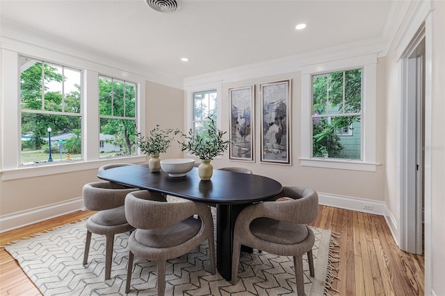 746 Mississippi Ave, Lakeland, FL 33801 - dining room with baseboards, visible vents, ornamental molding, and wood finished floors