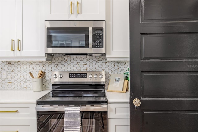 746 Mississippi Ave, Lakeland, FL 33801 - kitchen with tasteful backsplash, white cabinetry, stainless steel appliances, and light countertops