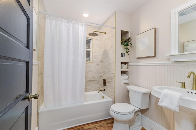 746 Mississippi Ave, Lakeland, FL 33801 - bathroom featuring shower / tub combo, wood finished floors, toilet, and wainscoting