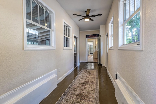 746 Mississippi Ave, Lakeland, FL 33801 - hallway with a textured wall, dark tile patterned floors, and baseboards