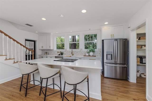 746 Mississippi Ave, Lakeland, FL 33801 - kitchen with white cabinets, visible vents, appliances with stainless steel finishes, and light countertops