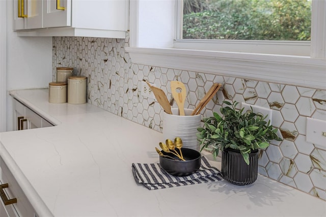 746 Mississippi Ave, Lakeland, FL 33801 - interior details with light stone countertops, white cabinets, and backsplash