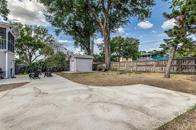 746 Mississippi Ave, Lakeland, FL 33801 - view of patio with an outbuilding, a storage shed, a sunroom, and a fenced backyard