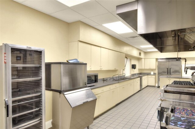 525 Eagle Run, Lakeland, FL 33809 - kitchen with wine cooler, a sink, appliances with stainless steel finishes, cream cabinets, and light tile patterned floors