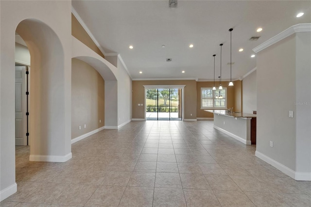 1295 Osprey Landing Dr, Lakeland, FL 33813 - unfurnished living room featuring ornamental molding, recessed lighting, arched walkways, and baseboards