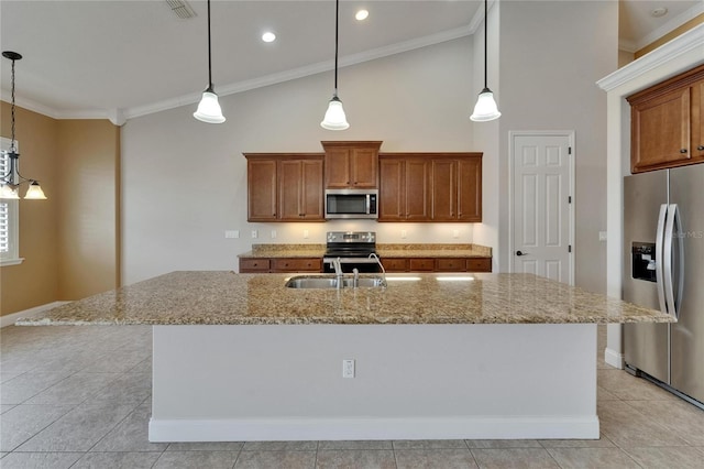 1295 Osprey Landing Dr, Lakeland, FL 33813 - kitchen with crown molding, appliances with stainless steel finishes, and brown cabinetry