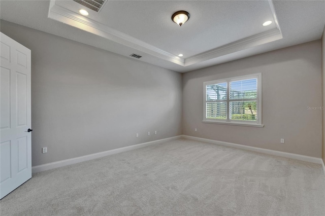 1295 Osprey Landing Dr, Lakeland, FL 33813 - unfurnished room featuring visible vents, baseboards, light carpet, and a tray ceiling