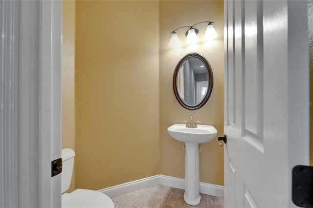 1295 Osprey Landing Dr, Lakeland, FL 33813 - half bathroom featuring baseboards, toilet, tile patterned flooring, and a sink