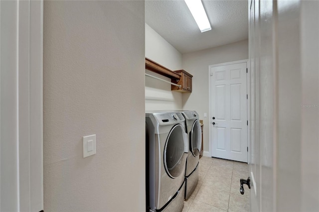1295 Osprey Landing Dr, Lakeland, FL 33813 - washroom featuring light tile patterned flooring, washer and clothes dryer, cabinet space, and a textured ceiling