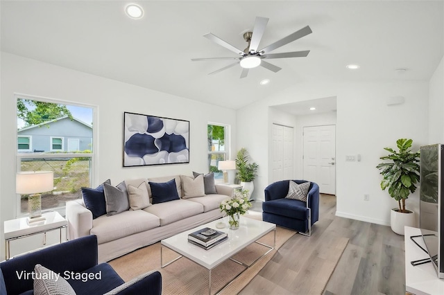 living room featuring lofted ceiling, baseboards, ceiling fan, light wood-type flooring, and recessed lighting