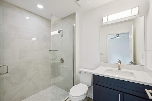 full bathroom with vanity, a stall shower, and toilet