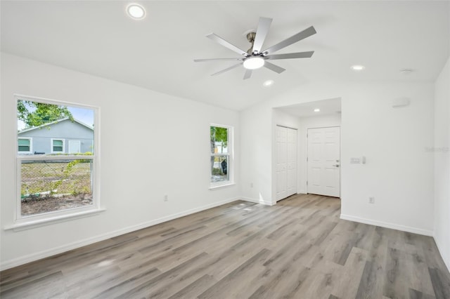 unfurnished bedroom featuring recessed lighting, baseboards, vaulted ceiling, and wood finished floors