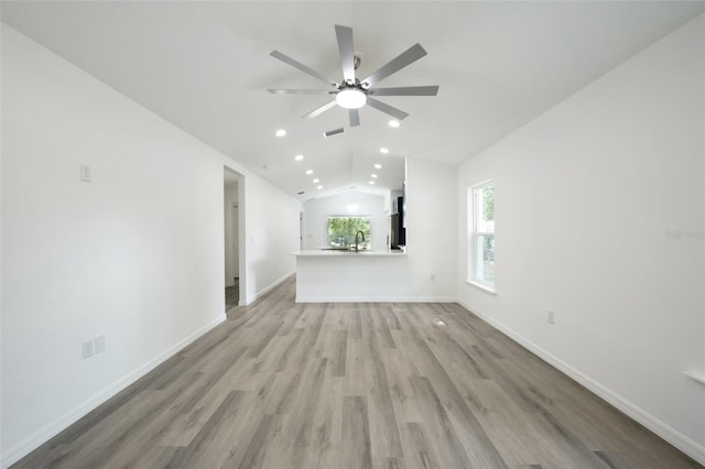 unfurnished living room with lofted ceiling, baseboards, ceiling fan, light wood-type flooring, and recessed lighting