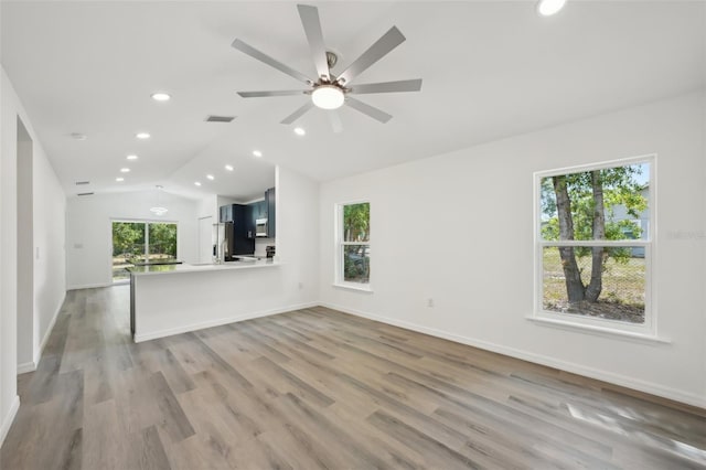 unfurnished living room featuring visible vents, light wood-style floors, ceiling fan, recessed lighting, and vaulted ceiling