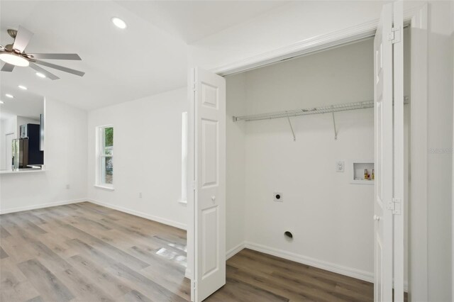 clothes washing area with laundry area, a ceiling fan, electric dryer hookup, wood finished floors, and hookup for a washing machine