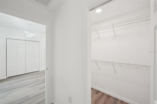 walk in closet featuring visible vents and wood finished floors