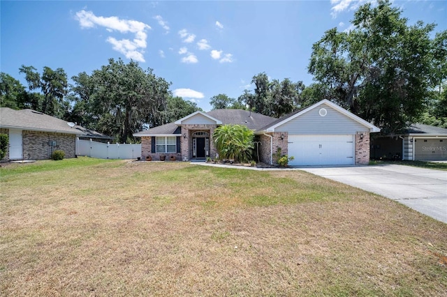 2933 Blackwater Oaks Dr, Mulberry, FL 33860 - view of front facade with brick siding, fence, a garage, a front lawn, and concrete driveway