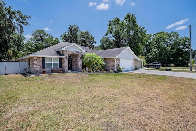 2933 Blackwater Oaks Dr, Mulberry, FL 33860 - ranch-style house featuring driveway, an attached garage, fence, brick siding, and a front lawn