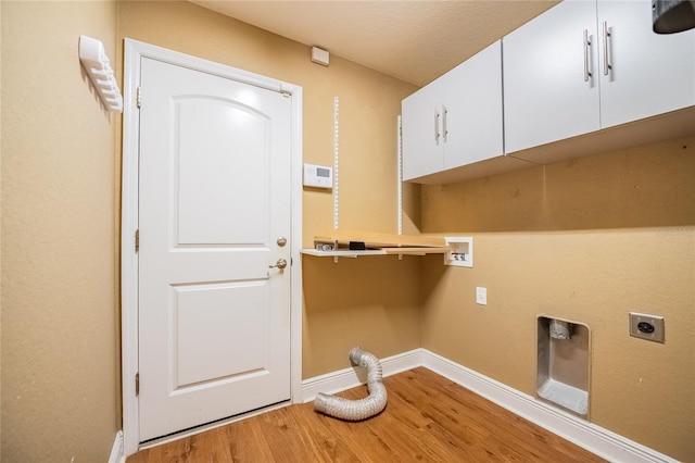 2933 Blackwater Oaks Dr, Mulberry, FL 33860 - washroom featuring hookup for a washing machine, cabinet space, hookup for an electric dryer, baseboards, and light wood-type flooring