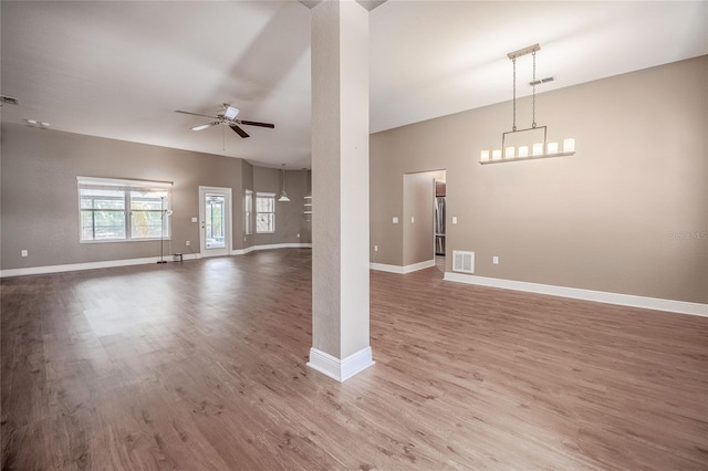 2933 Blackwater Oaks Dr, Mulberry, FL 33860 - unfurnished living room featuring wood finished floors, ceiling fan, visible vents, and baseboards