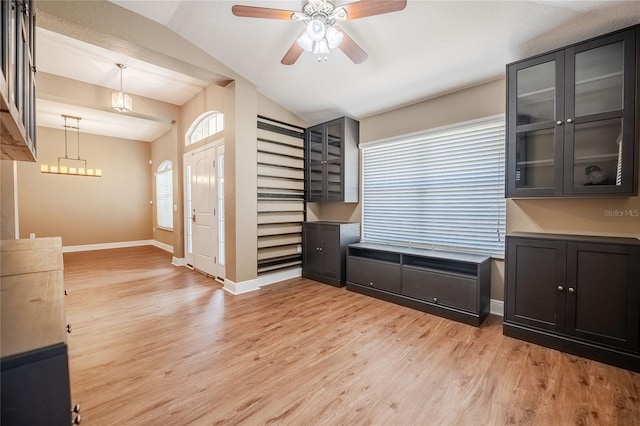 2933 Blackwater Oaks Dr, Mulberry, FL 33860 - interior space featuring baseboards, ceiling fan with notable chandelier, lofted ceiling, and light wood finished floors