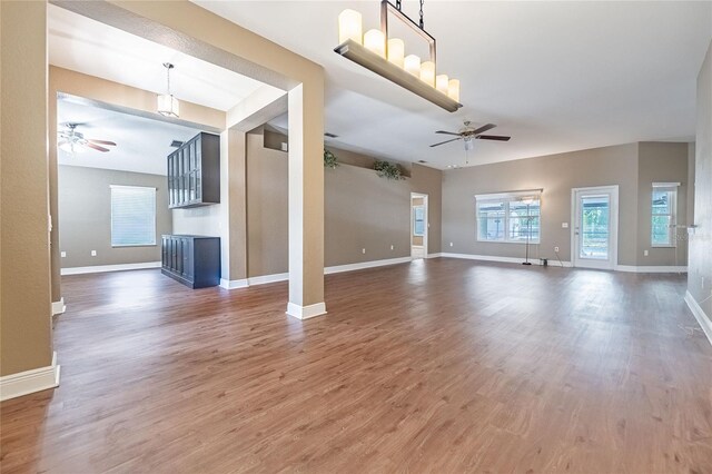2933 Blackwater Oaks Dr, Mulberry, FL 33860 - unfurnished living room featuring a wealth of natural light, wood finished floors, and a ceiling fan