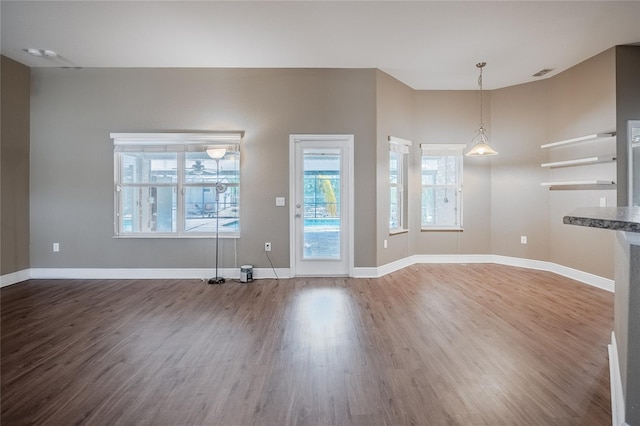 2933 Blackwater Oaks Dr, Mulberry, FL 33860 - unfurnished living room featuring wood finished floors, visible vents, and baseboards