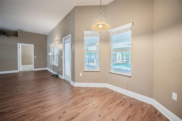 2933 Blackwater Oaks Dr, Mulberry, FL 33860 - foyer featuring baseboards, wood finished floors, and lofted ceiling