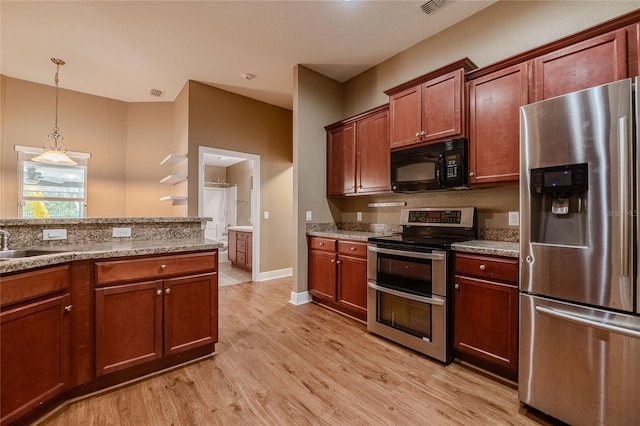 2933 Blackwater Oaks Dr, Mulberry, FL 33860 - kitchen featuring light stone countertops, stainless steel appliances, light wood finished floors, a sink, and pendant lighting