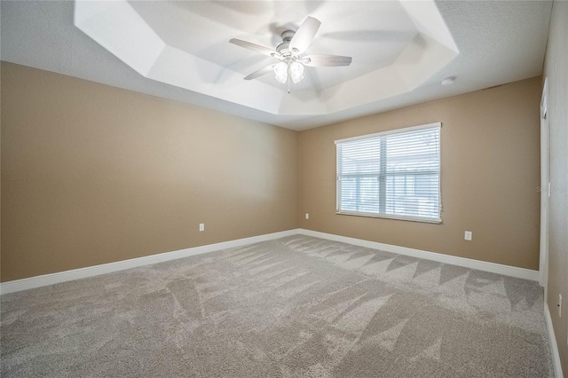 2933 Blackwater Oaks Dr, Mulberry, FL 33860 - empty room with a raised ceiling, ceiling fan, baseboards, and light carpet
