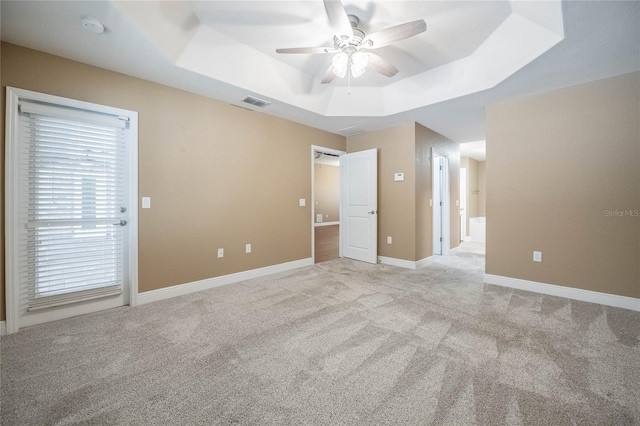 2933 Blackwater Oaks Dr, Mulberry, FL 33860 - unfurnished bedroom with ceiling fan, a raised ceiling, visible vents, baseboards, and light colored carpet